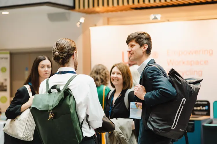 A group of delegates chat at an event 