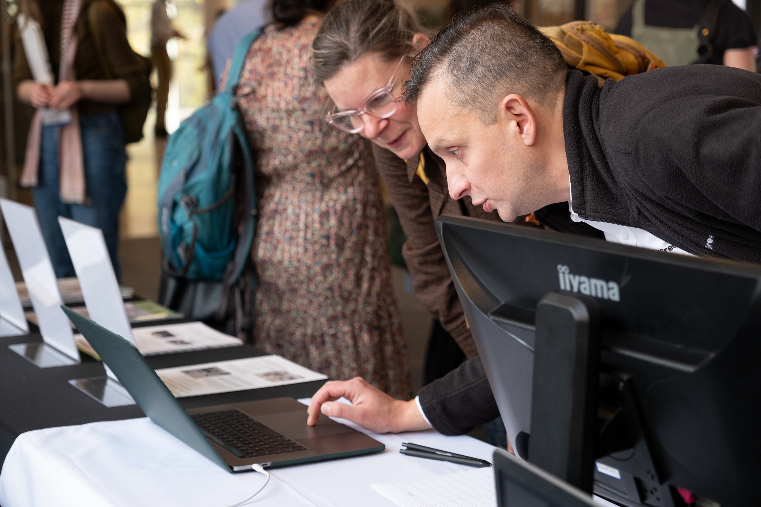 Two people looking at a computer screen. 